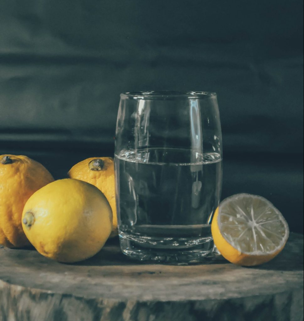 lemons with glass of water